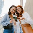 two women looking at phone